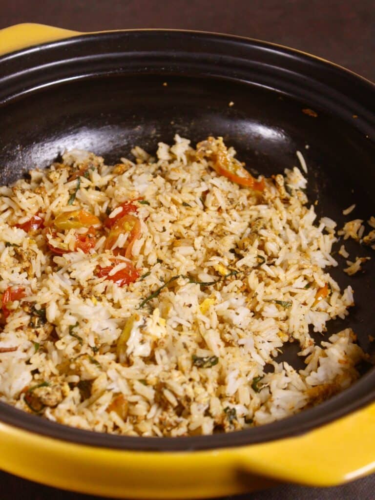 add cooked rice to the pan and mix well 