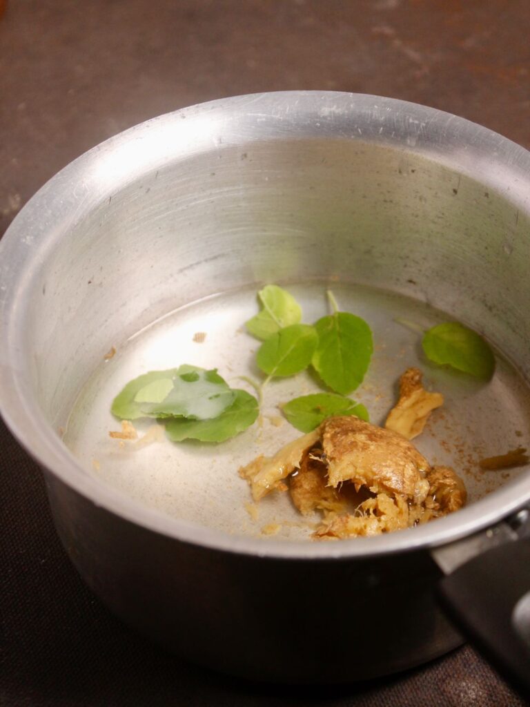 take basil leaves with ginger into the saucepan