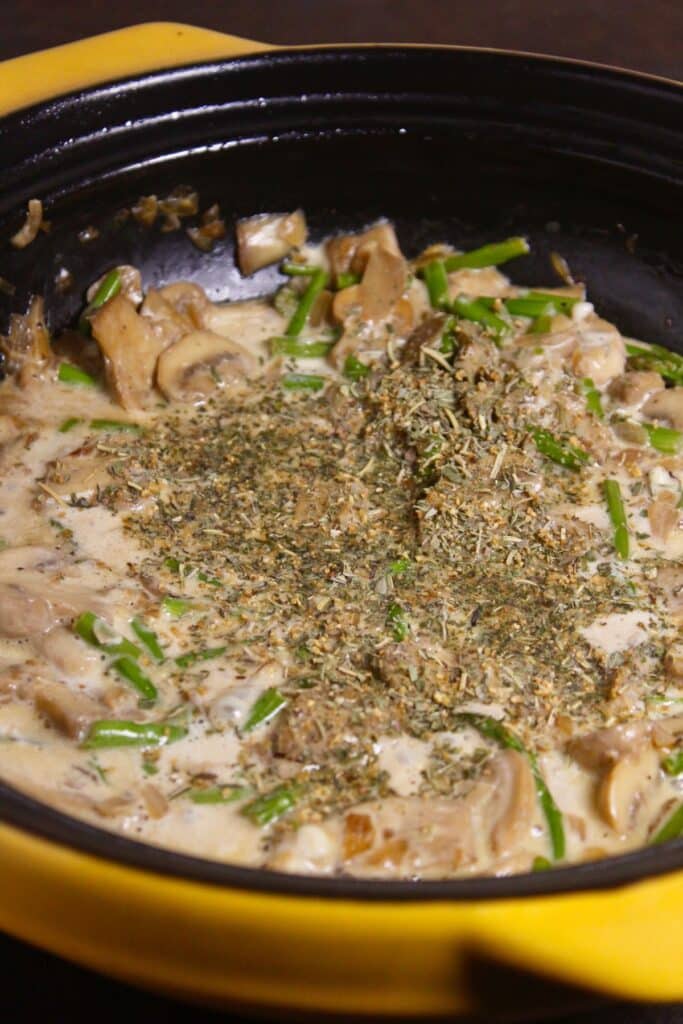 add mixed herbs seasonings to the pan and mix well 