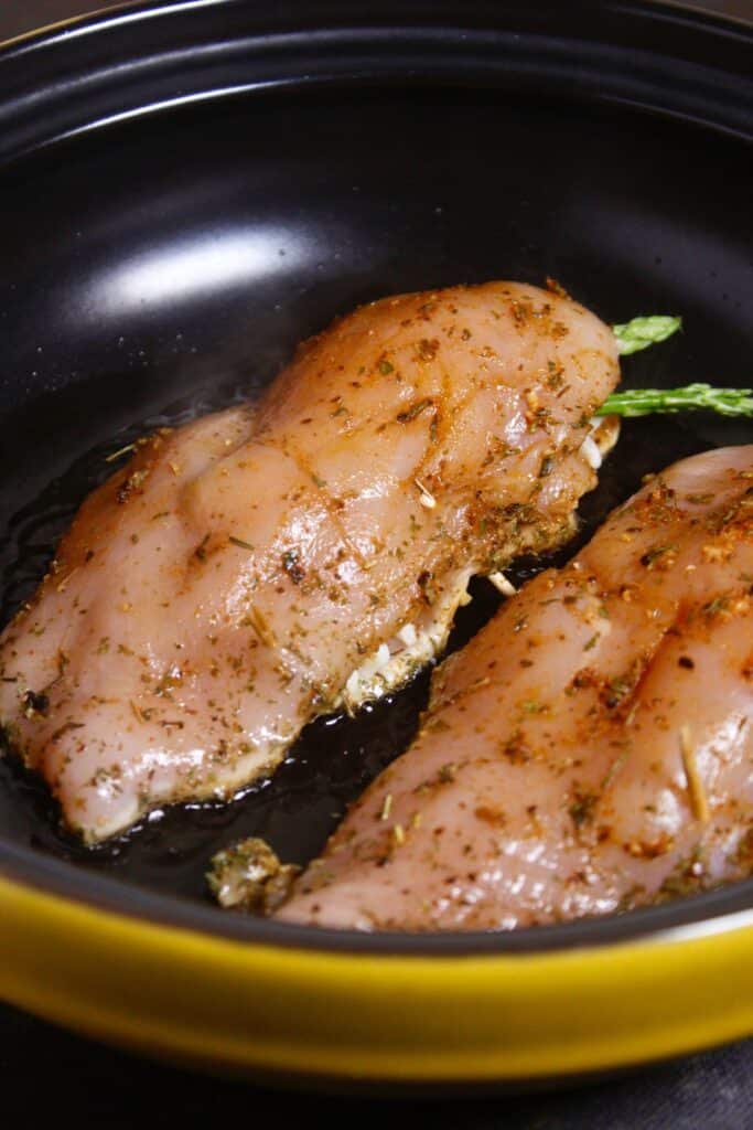 fry marinated chicken in a pan 