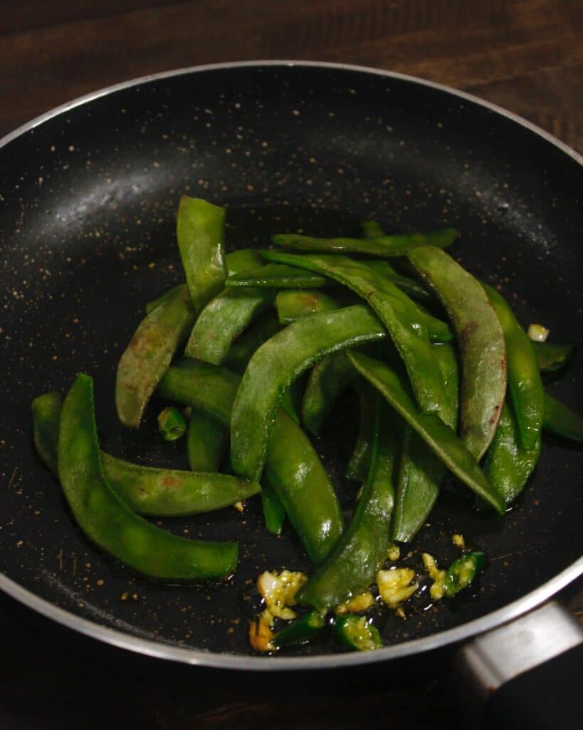 add broad beans to the pan 