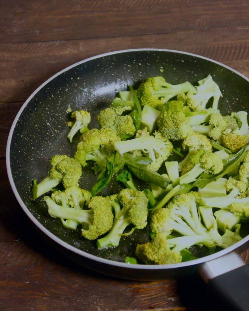 add broccoli florets in a pan with other vegetable 