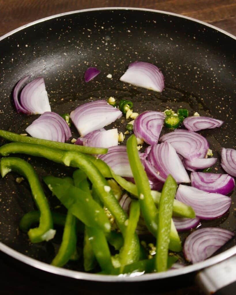 add sliced onions and other vegies to the pan 