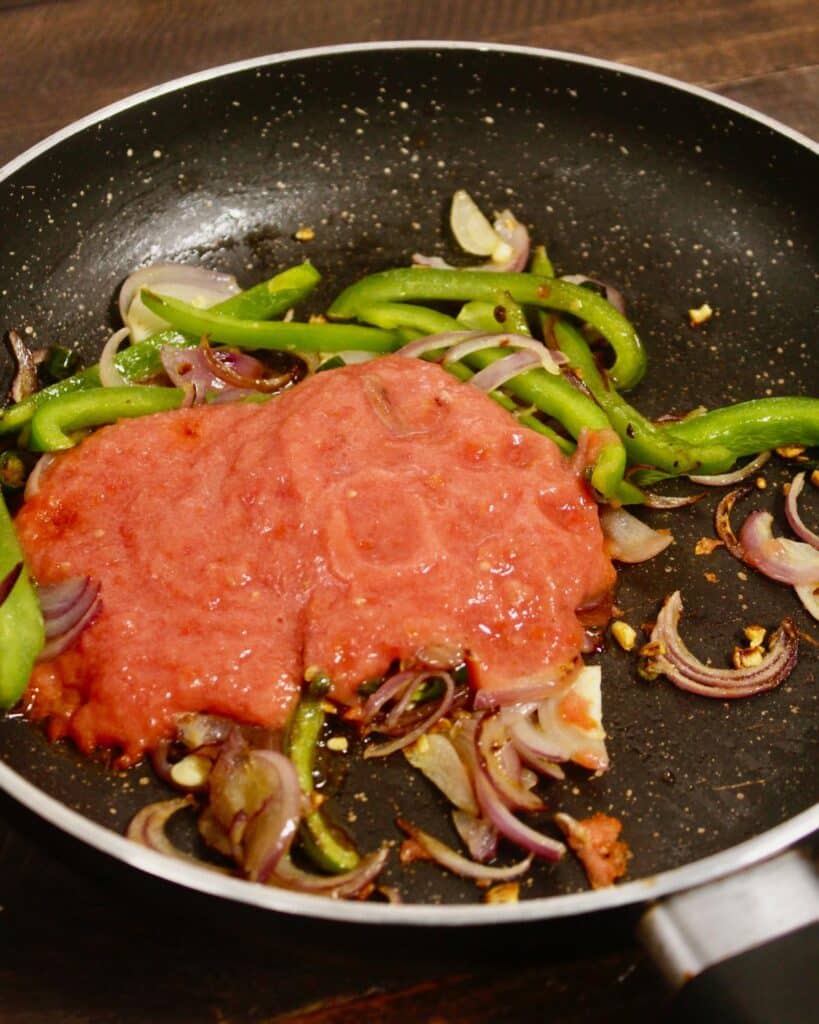 add tomato puree to the pan 