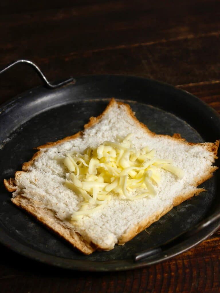 take bread and put some cheese on top of it 