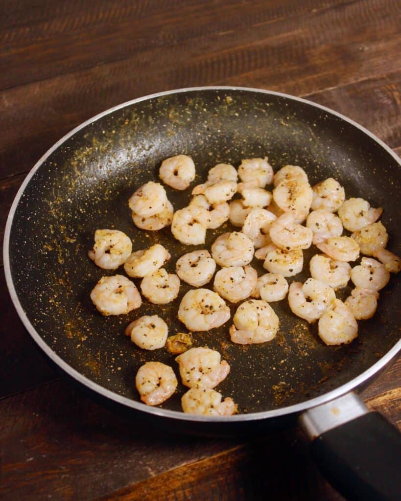 masala coated prawns in a pan 