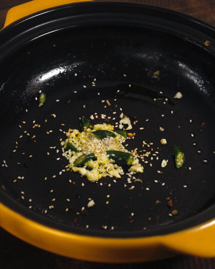 saute garlic, green chilies and seeds in a pan 