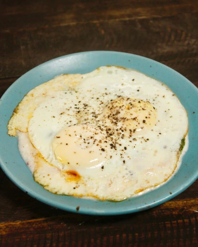 put the fried egg over the yogurt 