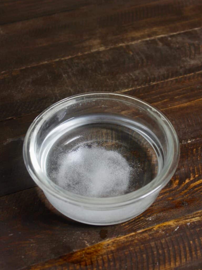 lukewarm water with sugar and salt in bowl