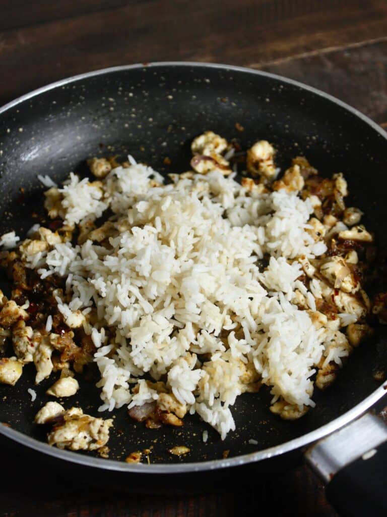 add boiled rice to the pan and mix well 