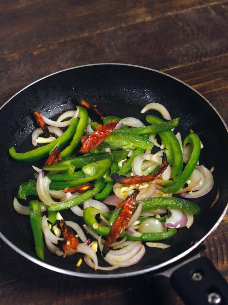 add dried tomatoes to the pan and mix well 