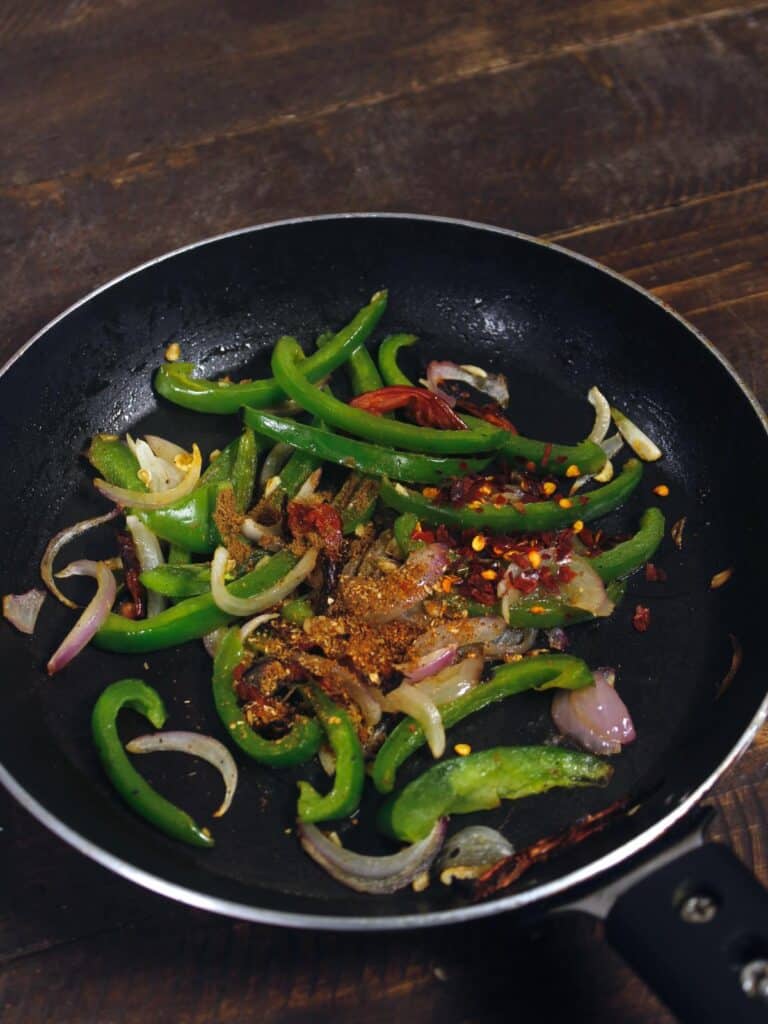 add powdered spices and chili flakes to the pan 