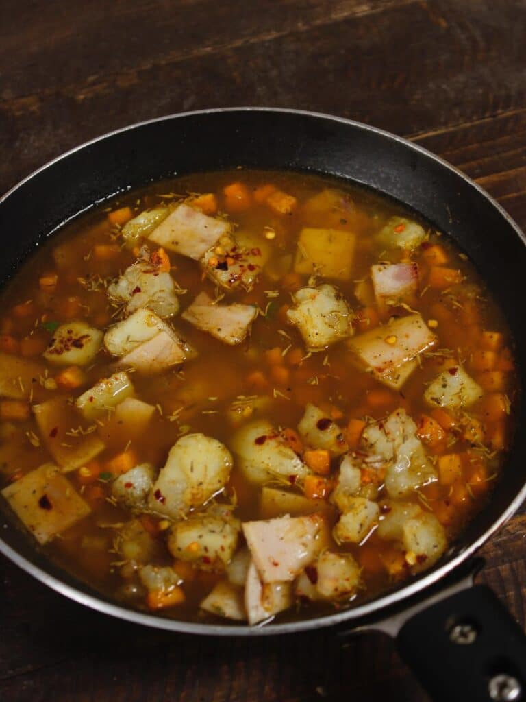 add vegetable broth to the pan and let it cook