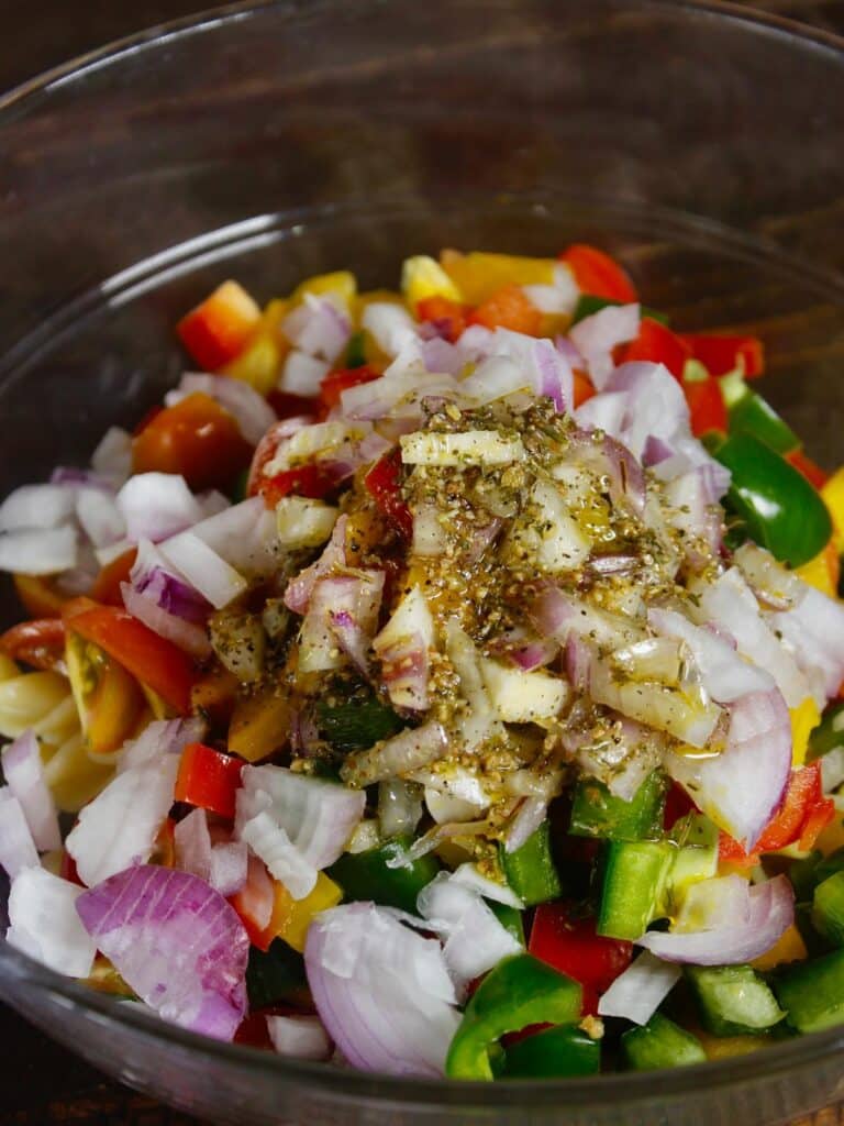 take boiled pasta and add all the chopped vegetables along with the dressing and mix well