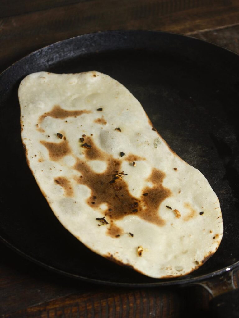 roast the naan on 1 side and keep turning until its cooked from both side 