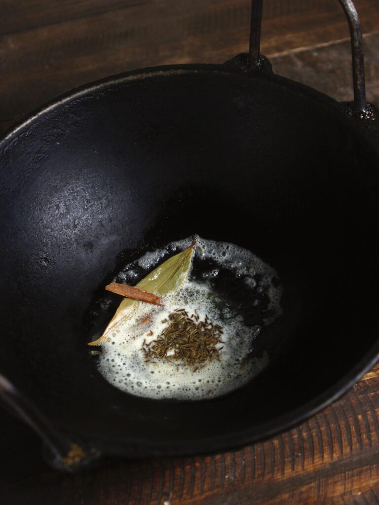 oil with dried spices in a pan 