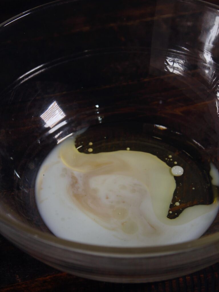 mix white egg part, milk and vanilla essence into the bowl and mix well 