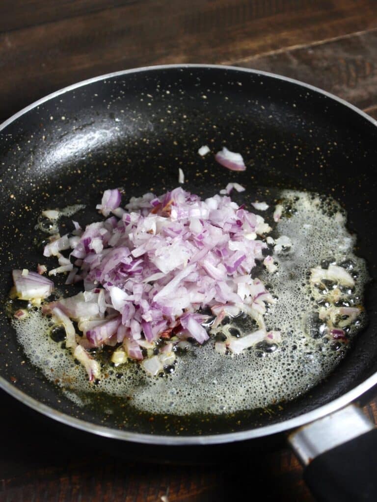 chopped onions with butter in a pan 