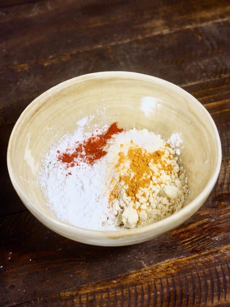 take corn flour and other powdered spices into the bowl 