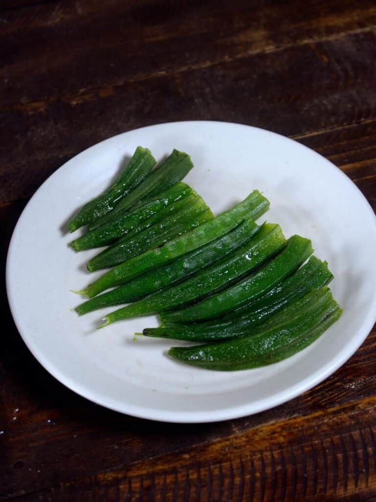 trim the edges of the boiled okras 