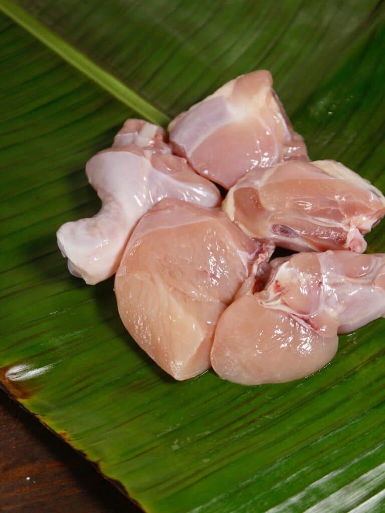chicken pieces on a banana leaf 