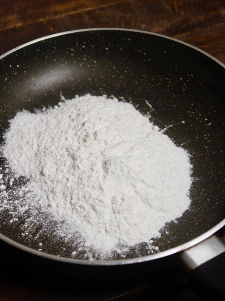 take flour in a pan 